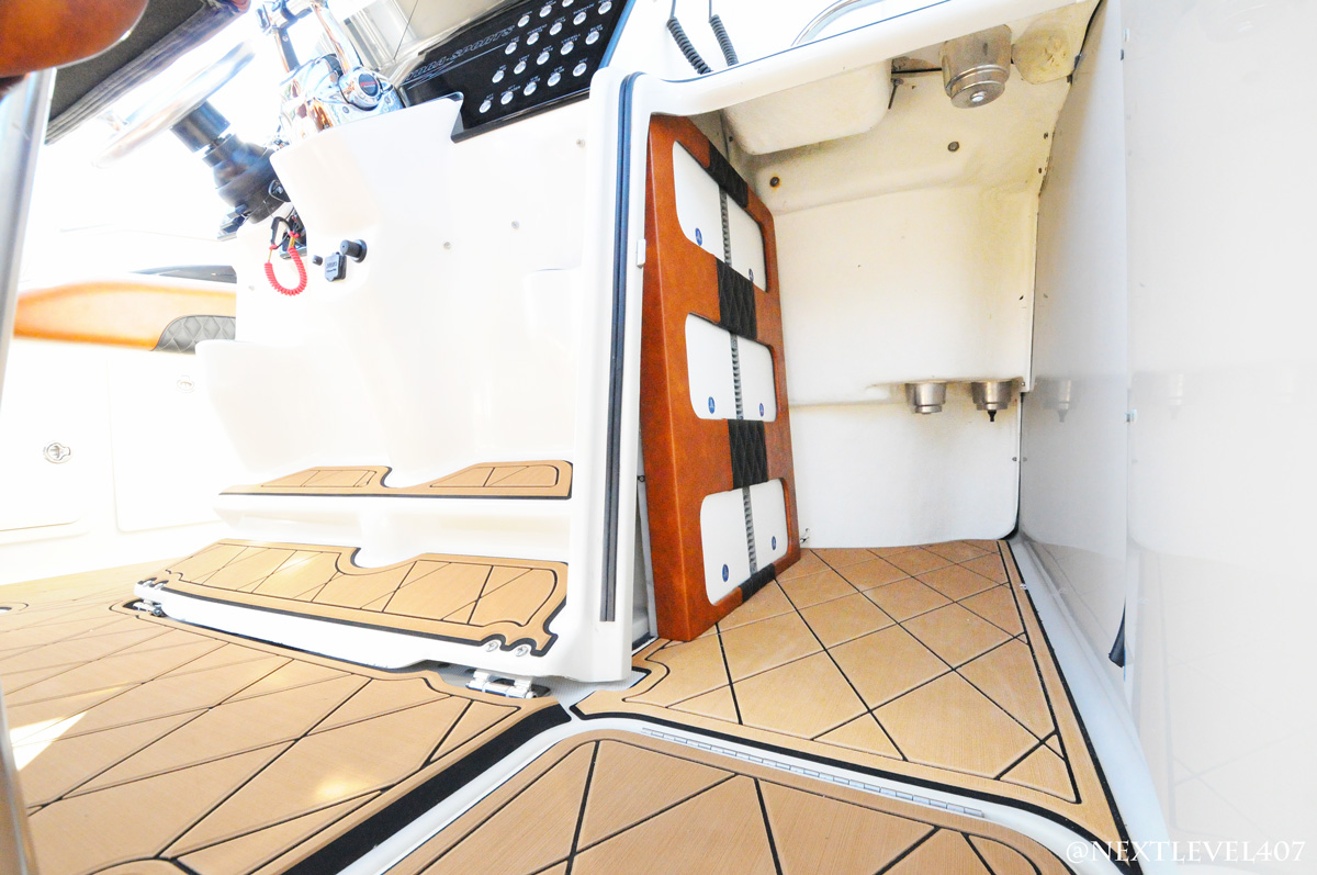 JL Audio amp custom install side photo. Upholstery and wire management. With SeaDek. Fishing boat, boat flooring, boat speakers, boat navigation upgrade orlando, Florida Marine Customs, Orlando Custom Audio, boat navigation